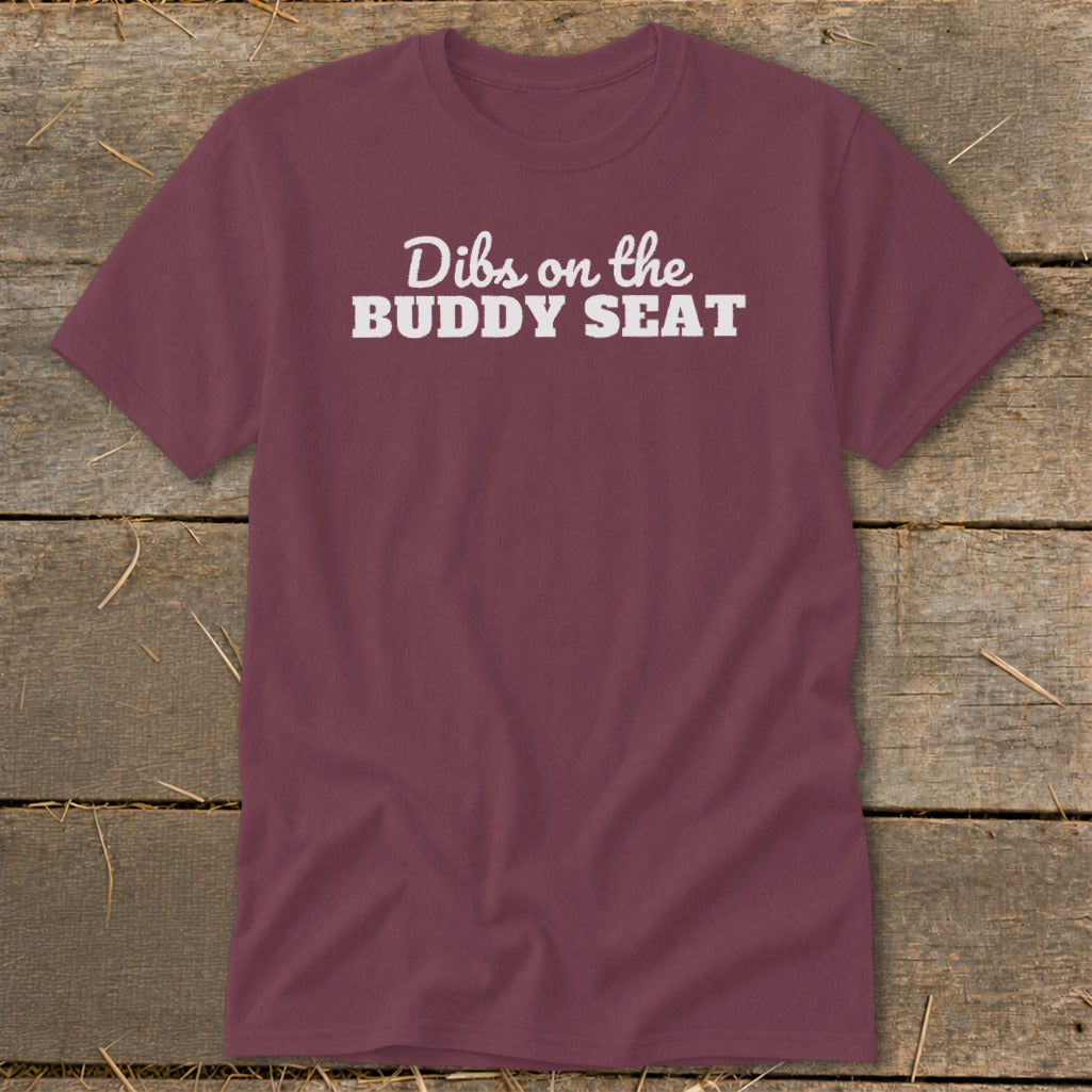 Maroon t-shirt with white text "Dibs on the BUDDY SEAT"