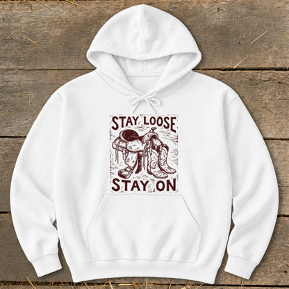 White hoodie with "STAY LOOSE STAY ON" text and cowboy saddle and boots graphic.