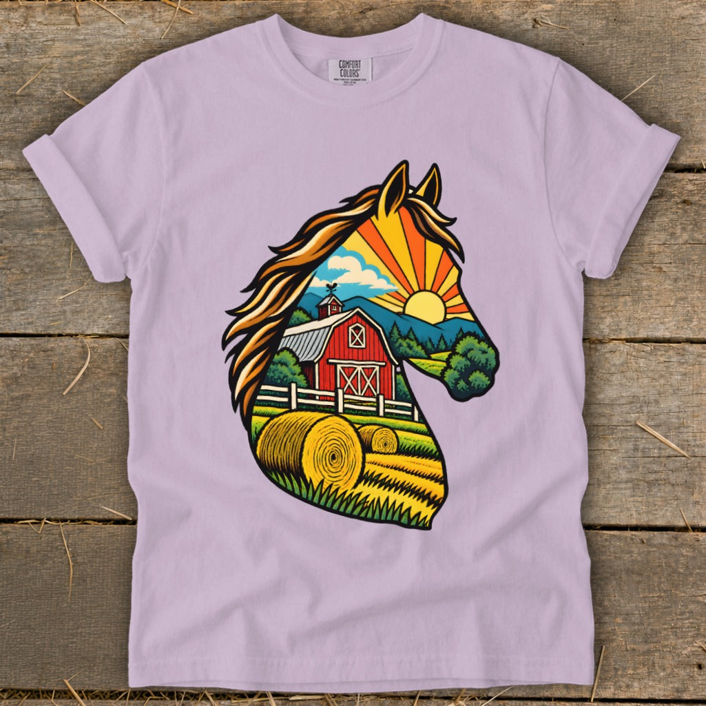 A light purple t-shirt featuring a graphic print of a horse head silhouette filled with a farm scene.