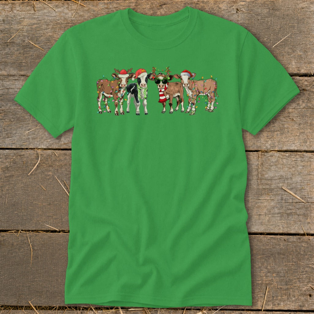 Five festive cows wearing Santa hats and Christmas lights on green t-shirt.