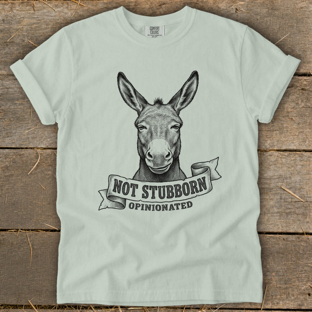 Light green t-shirt with a drawing of a donkey and text "Not Stubborn, Opinionated".