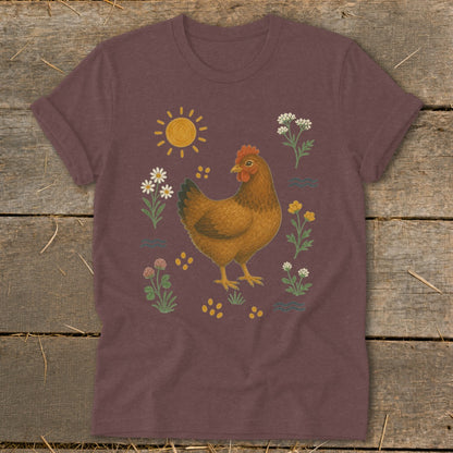 Brown hen illustration with sun and flowers on a maroon t-shirt.