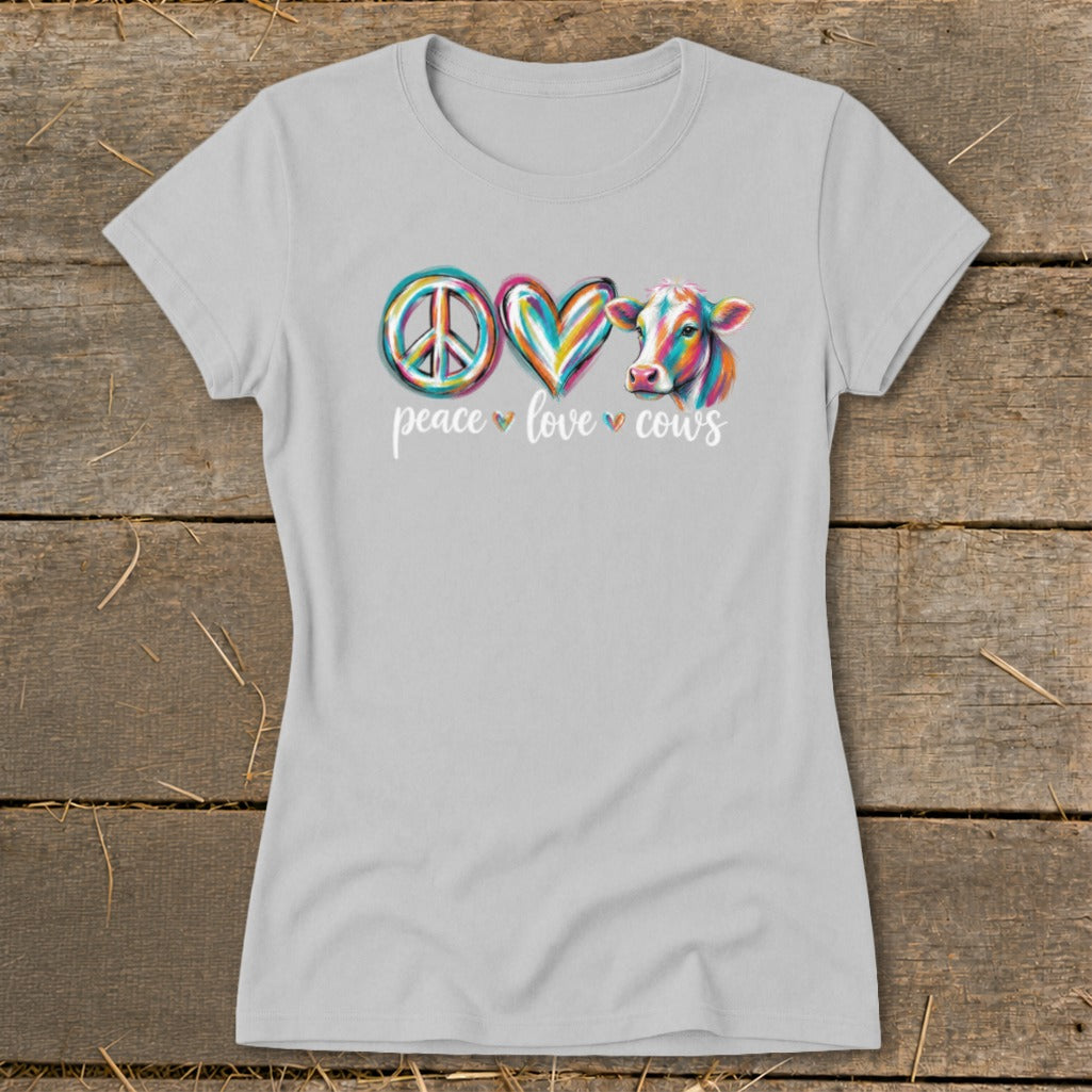Light grey t-shirt with colorful peace, heart, and cow graphic and text "peace love cows".