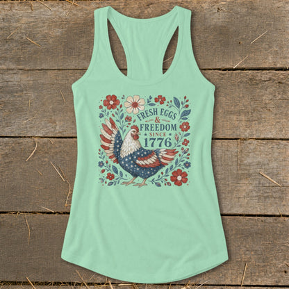 Mint green tank top with a chicken graphic and text "Fresh Eggs & Freedom Since 1776".