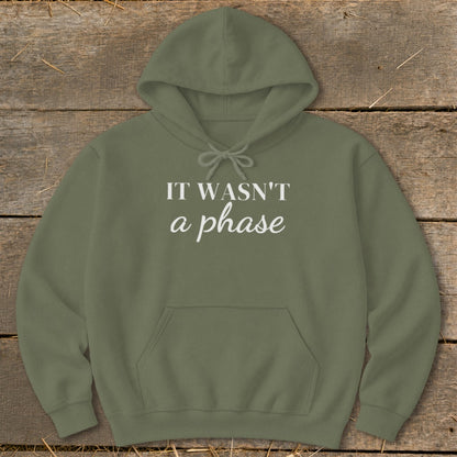 Olive green hoodie with white text "IT WASN'T a phase".