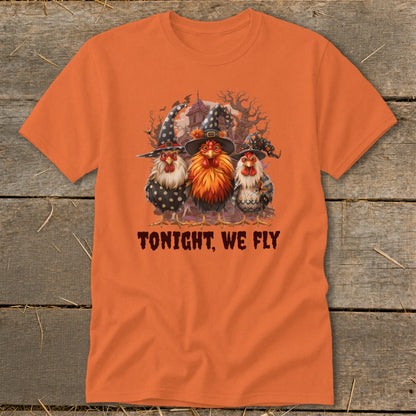 Three chickens in witch hats on an orange t-shirt with text "TONIGHT, WE FLY".