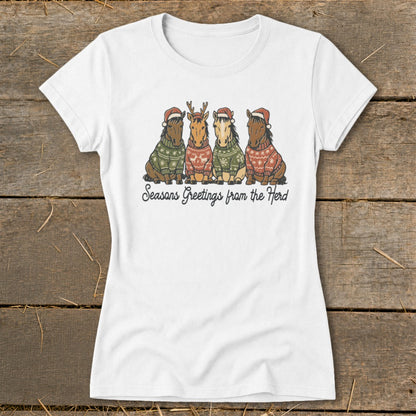 White t-shirt with four horses wearing Santa hats and sweaters, text reads "Seasons Greetings from the Herd".