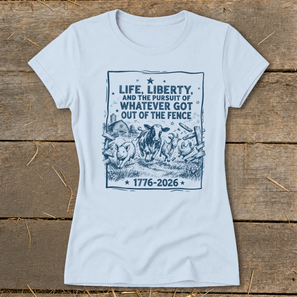 Light blue t-shirt with blue graphic of farm animals and text: "Life, Liberty, and the Pursuit of Whatever Got Out of the Fence 1776-2026."