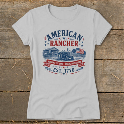 White t-shirt with "American Rancher" graphic, tractor, barn, flag, and "Est. 1776".