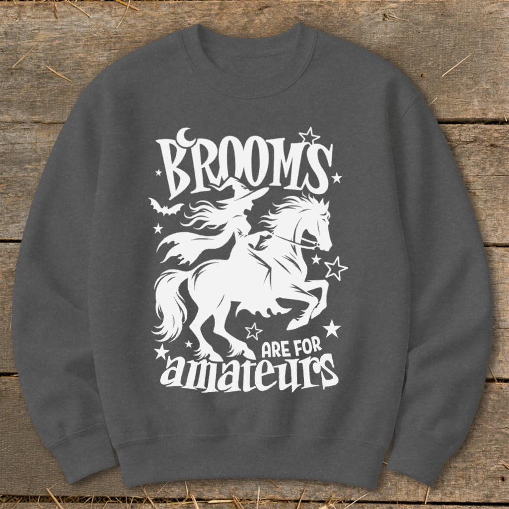 Dark grey sweatshirt with white Halloween graphic: witch on horse, "Brooms are for amateurs."