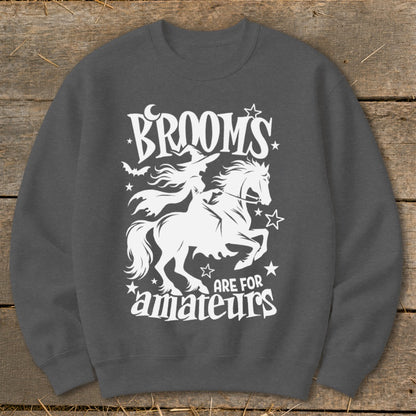 Dark grey sweatshirt with white Halloween graphic: witch on horse, "Brooms are for amateurs."