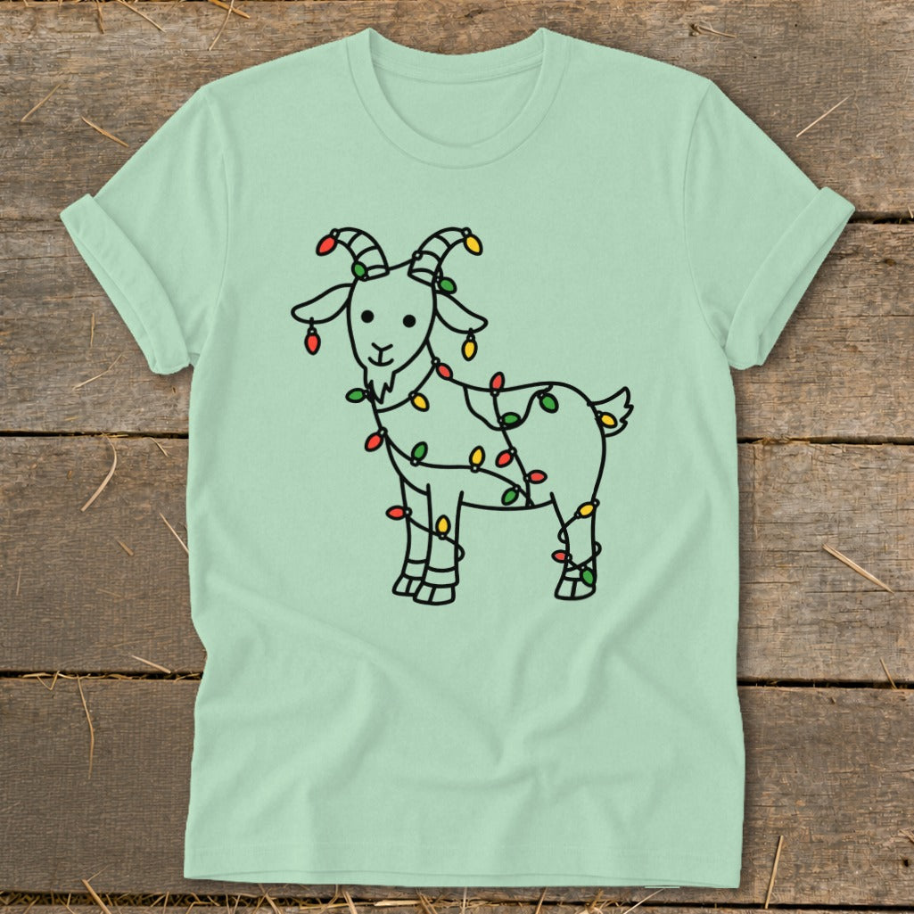 Line drawing of a goat adorned with colorful Christmas lights on a mint green t-shirt.