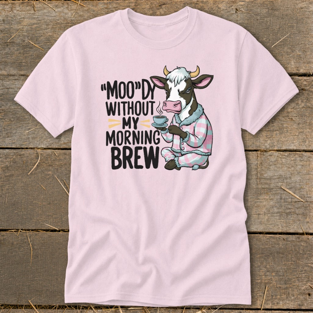 Pink t-shirt with cow in pajamas drinking coffee and text "Moo-dy without my morning brew".