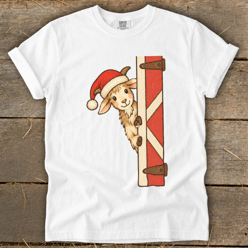 Christmas llama wearing a Santa hat peeking around a barn door.