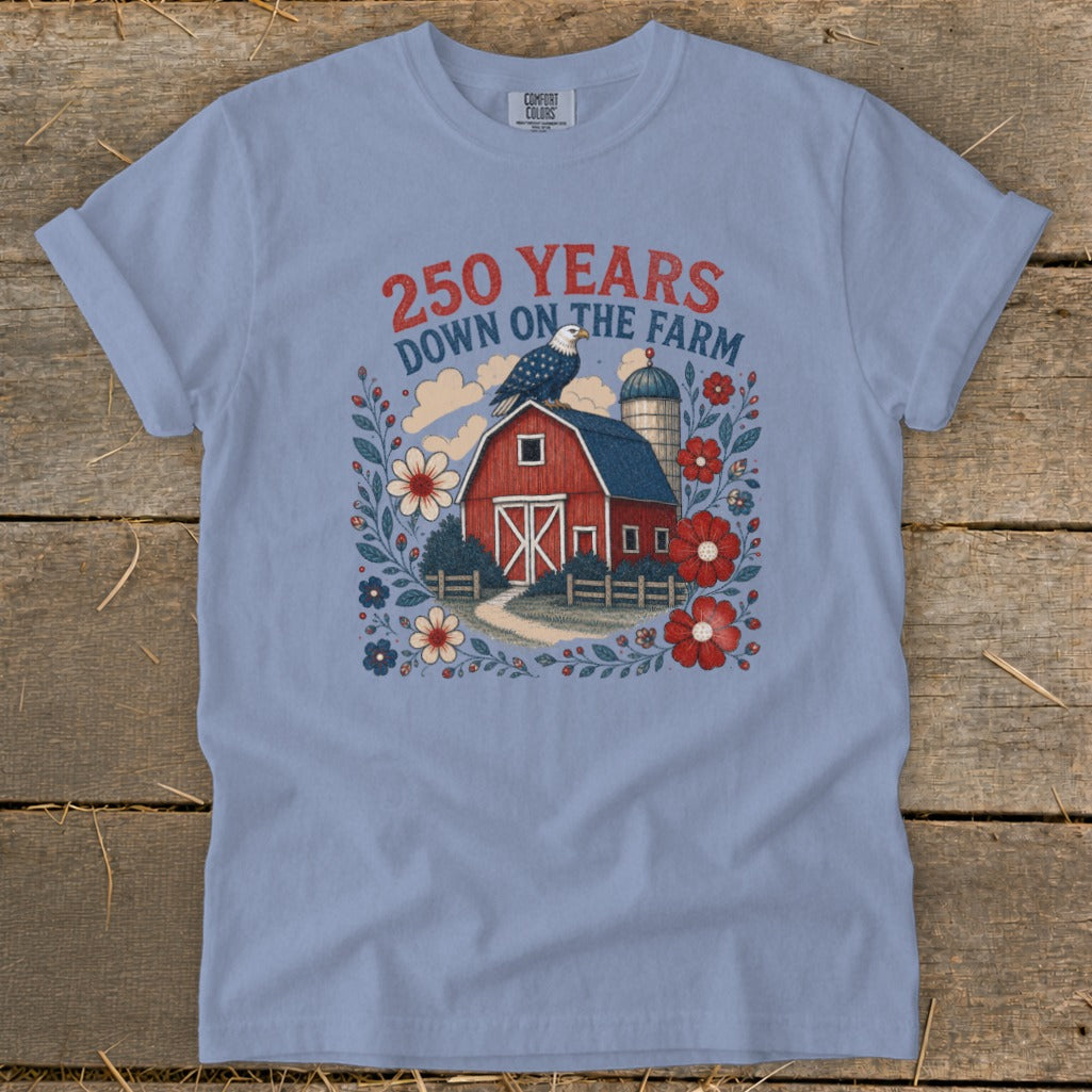 Light blue t-shirt with graphic of red barn, eagle, silo, and flowers, reading "250 YEARS DOWN ON THE FARM".