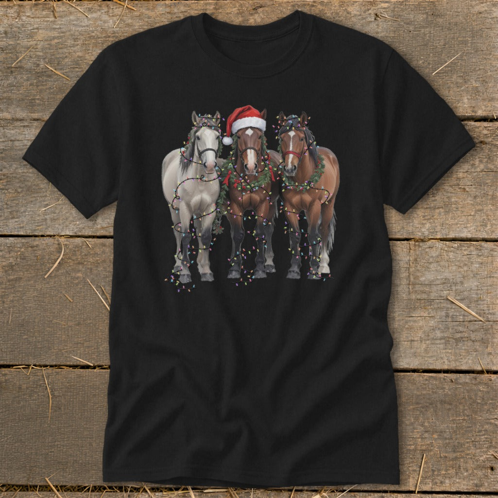 Three horses, one with a Santa hat, decorated with Christmas lights and garland.