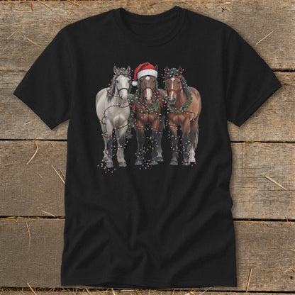 Three horses, one with a Santa hat, decorated with Christmas lights and garland.