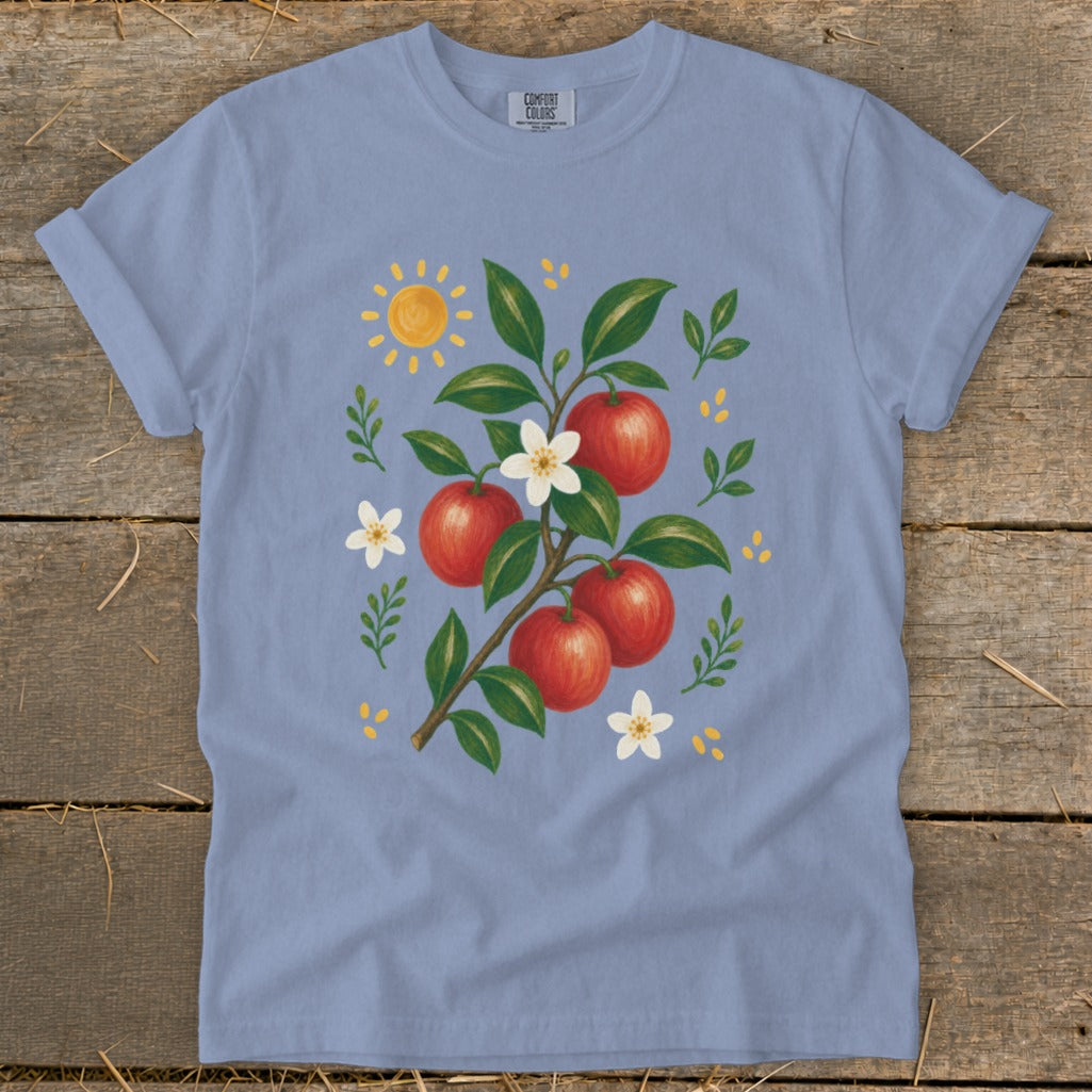 Light blue Comfort Colors t-shirt with apple branch and sun graphic.