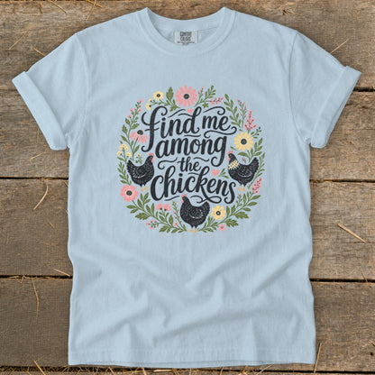 Light blue t-shirt with floral wreath and chickens graphic that reads "Find me among the chickens."