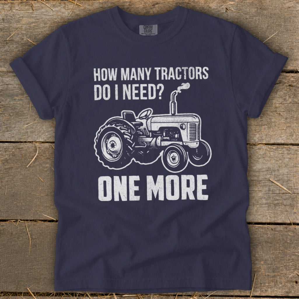 Navy t-shirt with white text and tractor graphic: "How Many Tractors Do I Need? One More."