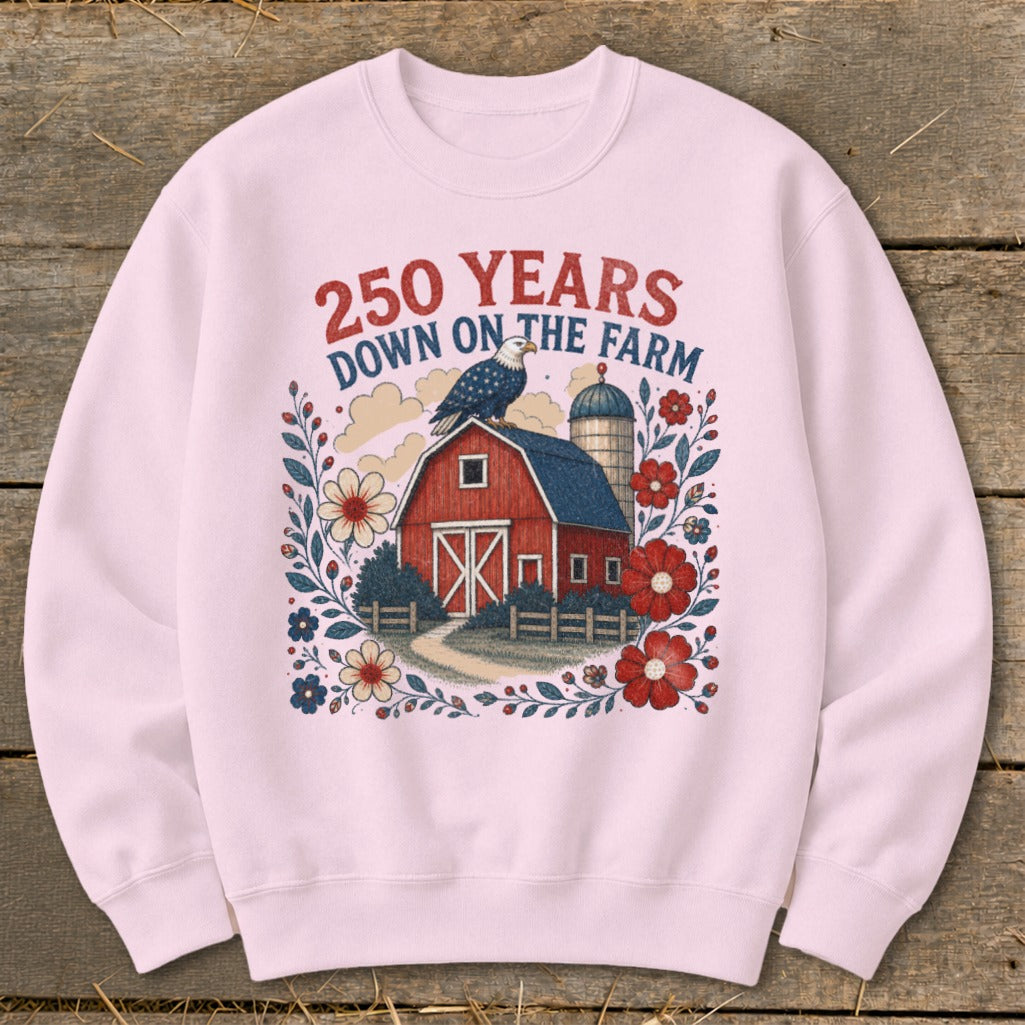 Pink sweatshirt with red, white, and blue farm scene and "250 YEARS DOWN ON THE FARM" text.