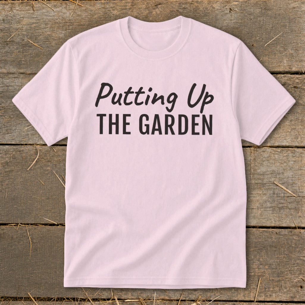 Pink t-shirt with black text that reads "Putting Up THE GARDEN".