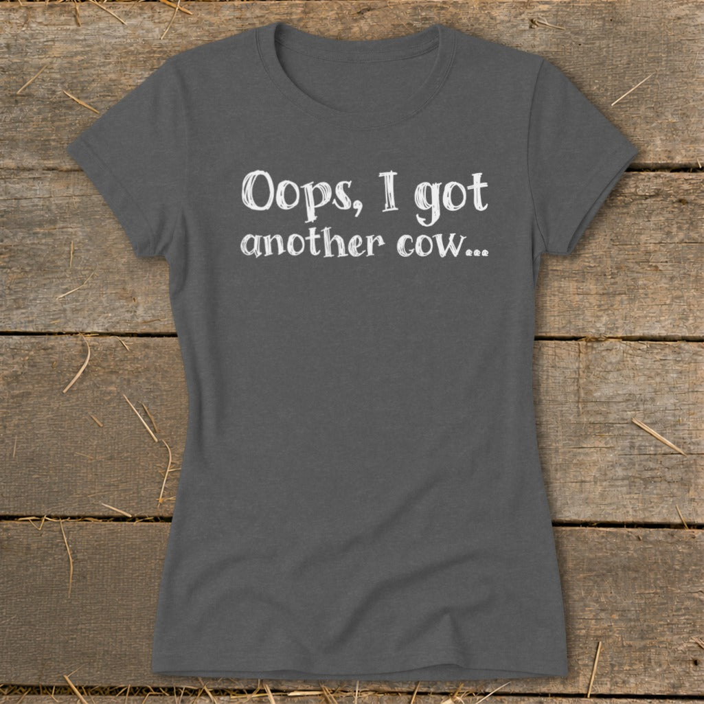Grey t-shirt with white text that reads "Oops, I got another cow...".