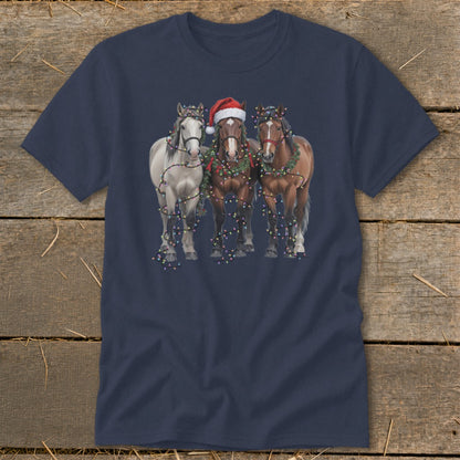 Three horses wearing Christmas lights and garlands, one with Santa hat.