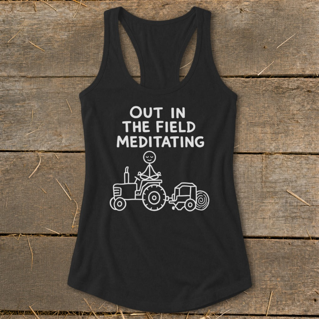 Black tank top with white text and drawing of stick figure meditating on tractor.