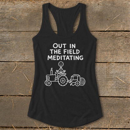 Black tank top with white text and drawing of stick figure meditating on tractor.