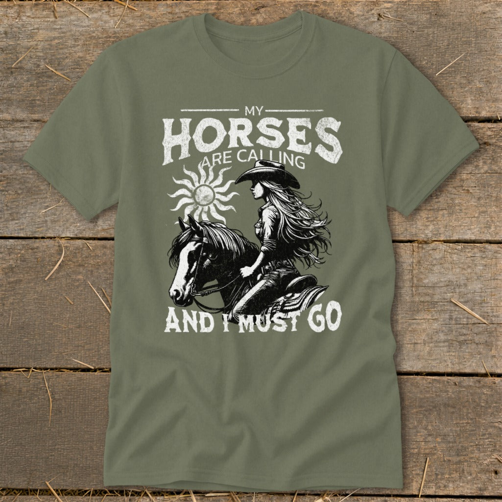 Green t-shirt with distressed graphic of a woman riding a horse, "My Horses Are Calling And I Must Go" text.