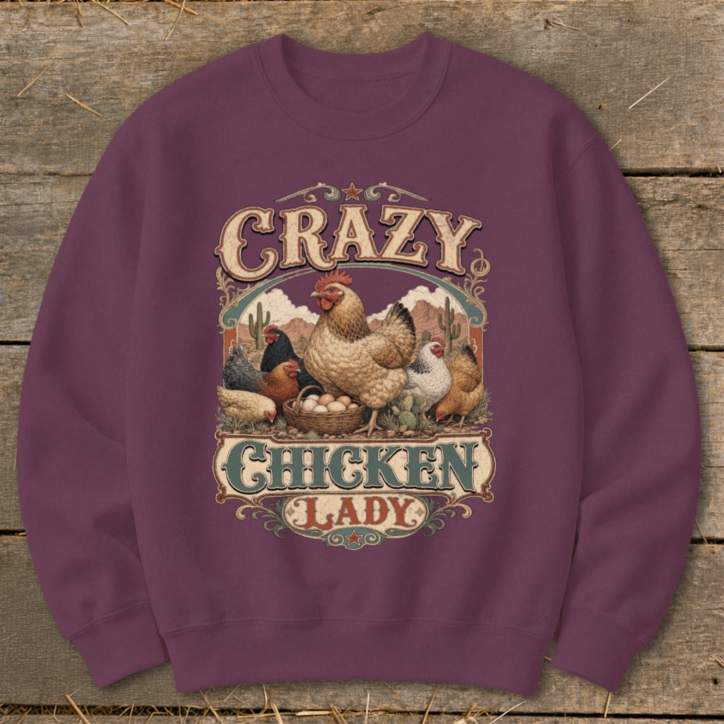 Crewneck sweatshirt with "Crazy Chicken Lady" graphic featuring chickens and eggs in a desert landscape.