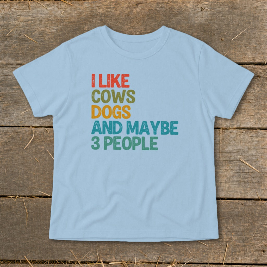 Light blue t-shirt with text "I LIKE COWS DOGS AND MAYBE 3 PEOPLE"
