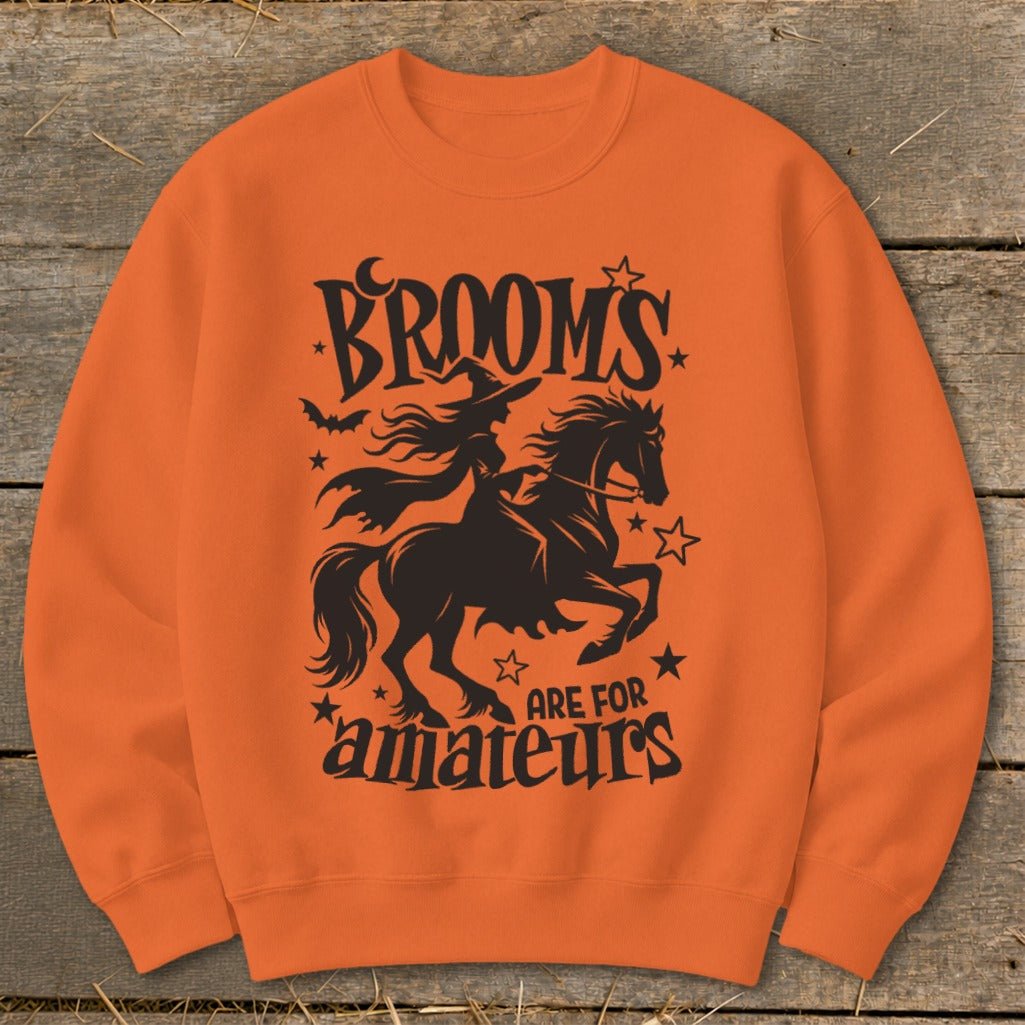 Orange sweatshirt with black Halloween graphic: witch on horse, "Broom's are for amateurs".