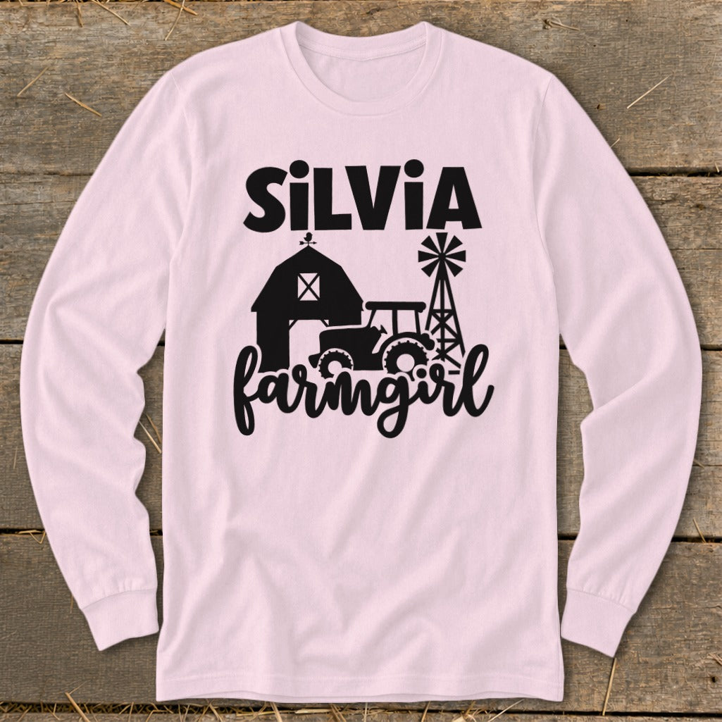 Pink long sleeve shirt with black text "SILVIA" and farm graphic.