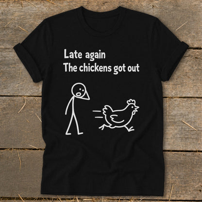 Black t-shirt with white text and stick figures: "Late again The chickens got out".