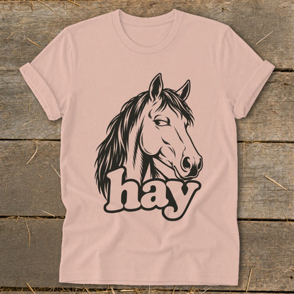 Pink t-shirt with black horse head graphic and "hay" text.