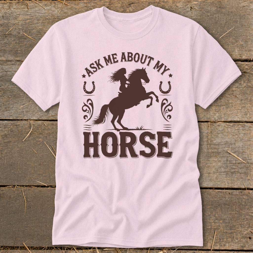 Pink t-shirt with dark brown text and silhouette of a rider on a rearing horse.