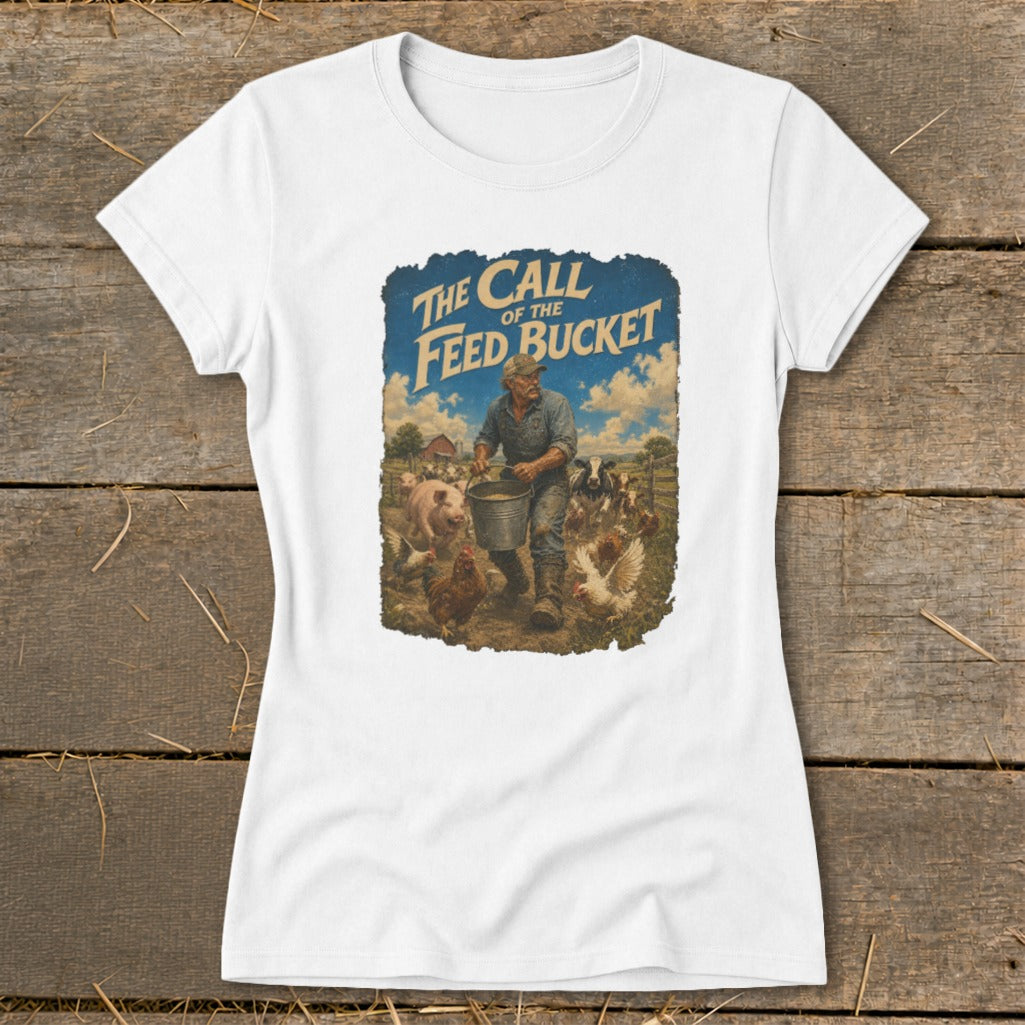 White t-shirt with "The Call of the Feed Bucket" text and farm illustration.