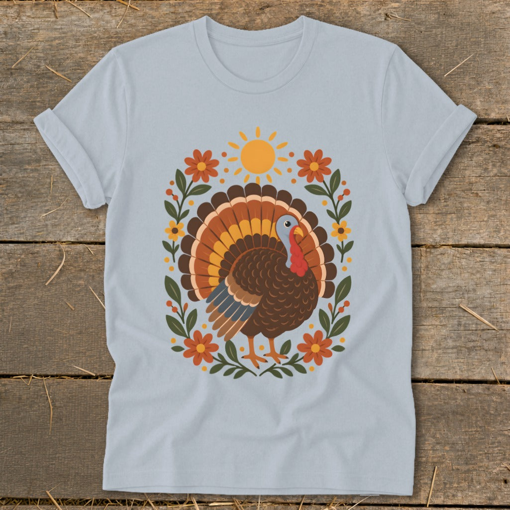 Light blue t-shirt with a Thanksgiving turkey design featuring a sun and floral wreath.