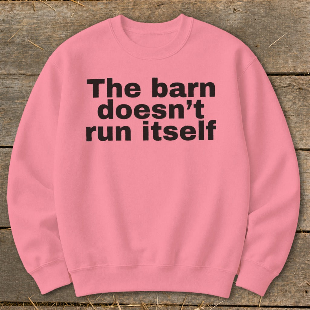 Pink sweatshirt with black text that reads "The barn doesn't run itself".
