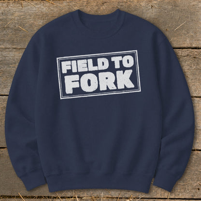 Dark blue crewneck sweatshirt with the white text FIELD TO FORK inside a distressed rectangular box.