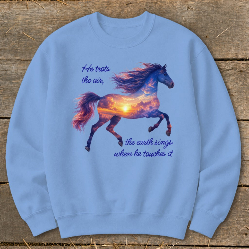 A light blue crewneck sweatshirt featuring a graphic of a galloping horse filled with sunset clouds and inspirational text.