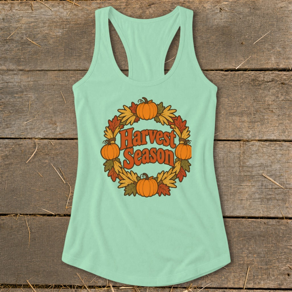 Mint green tank top with "Harvest Season" text in a wreath of pumpkins and fall leaves.