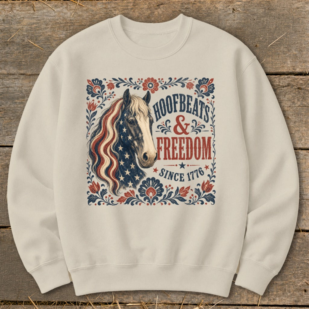 Cream sweatshirt with a horse graphic and text "Hoofbeats & Freedom Since 1776."