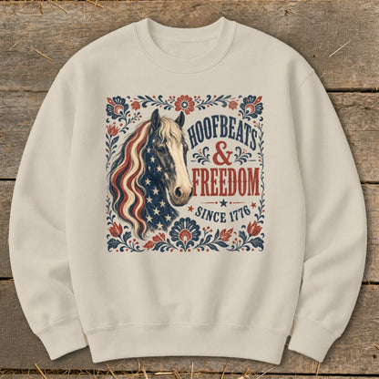 Cream sweatshirt with a horse graphic and text "Hoofbeats & Freedom Since 1776."