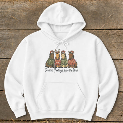 White hoodie with a festive horse herd graphic and "Seasons Greetings from the Herd" text.