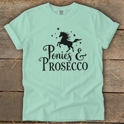 Mint green t-shirt with black graphic of a horse and "Ponies & Prosecco" text.