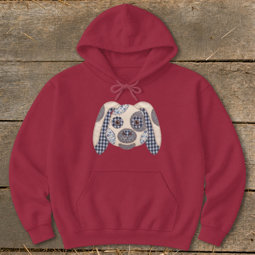 Maroon hoodie with a patchwork dog face applique on the chest.