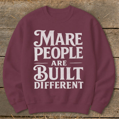 Marbled burgundy sweatshirt with "Mare People Are Built Different" graphic print.